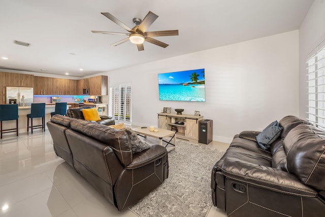 tiled living room with ceiling fan