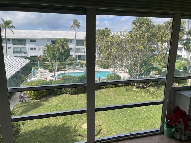 view of community with a lawn and a pool