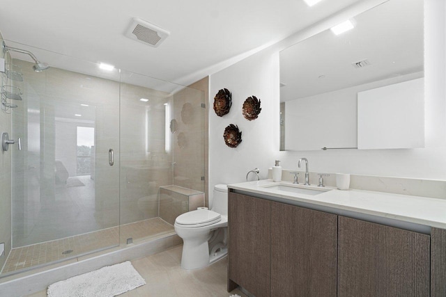 bathroom with toilet, vanity, tile patterned floors, and walk in shower