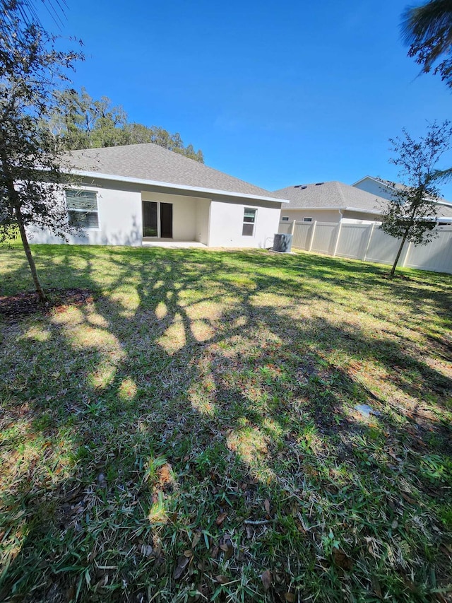 back of house with a yard