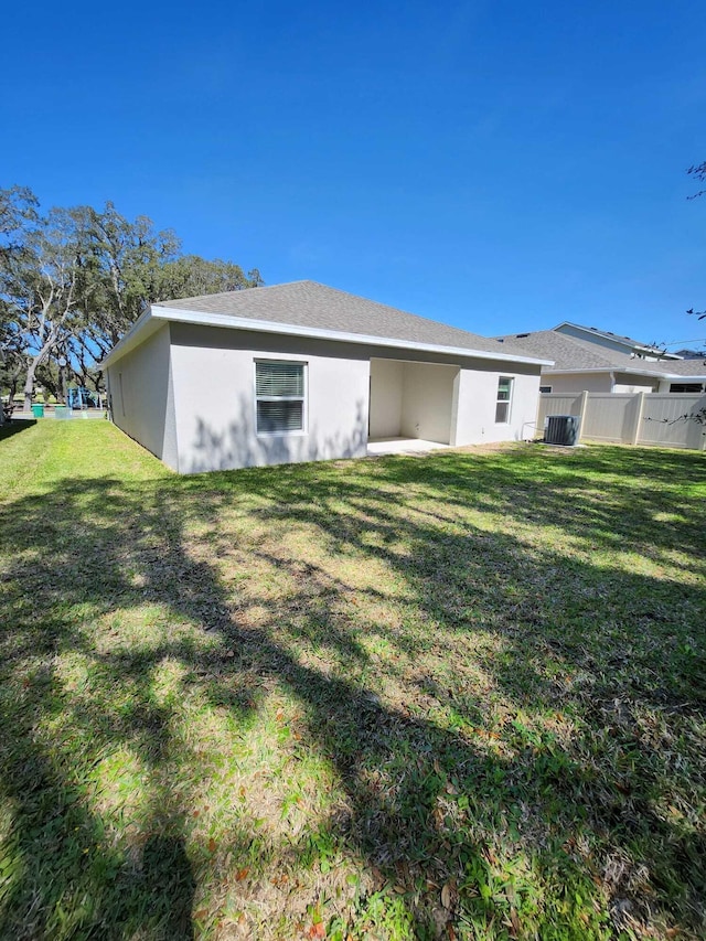 rear view of property featuring a lawn