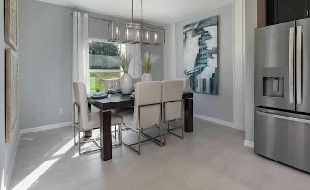 tiled dining room featuring a notable chandelier