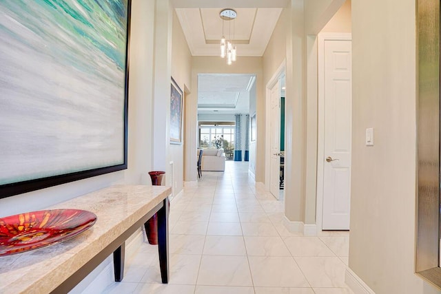 hallway featuring a raised ceiling and light tile patterned floors