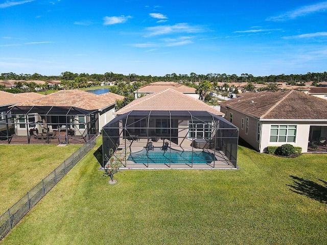 back of house featuring a fenced in pool, a patio area, a yard, and glass enclosure