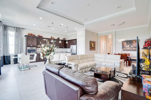 tiled living room featuring a raised ceiling, ornamental molding, and sink