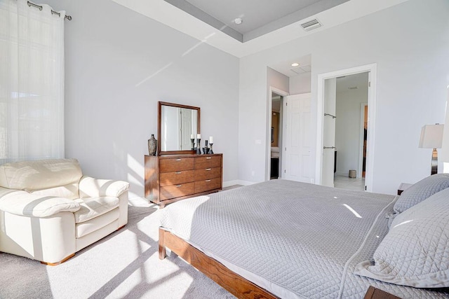 carpeted bedroom featuring ensuite bathroom