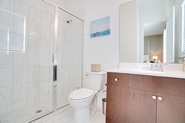 bathroom with vanity, toilet, and an enclosed shower