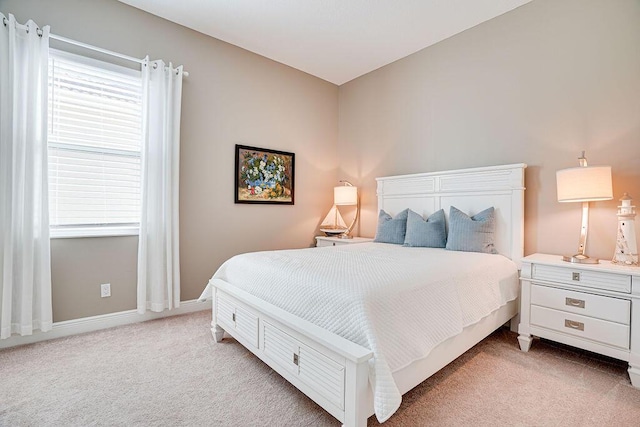 carpeted bedroom featuring multiple windows