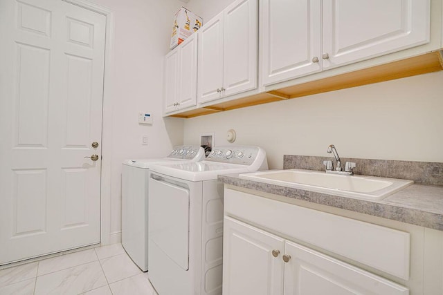 laundry area with washer and clothes dryer, cabinets, and sink