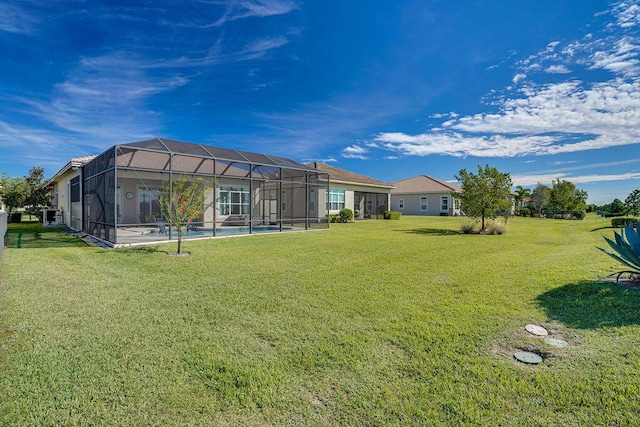 view of yard featuring a lanai and a swimming pool