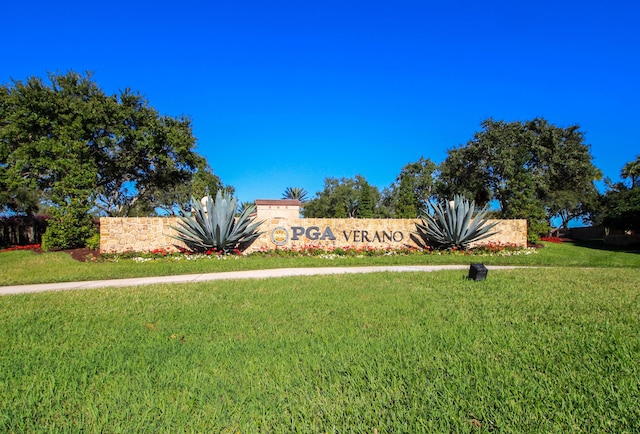 community sign featuring a yard