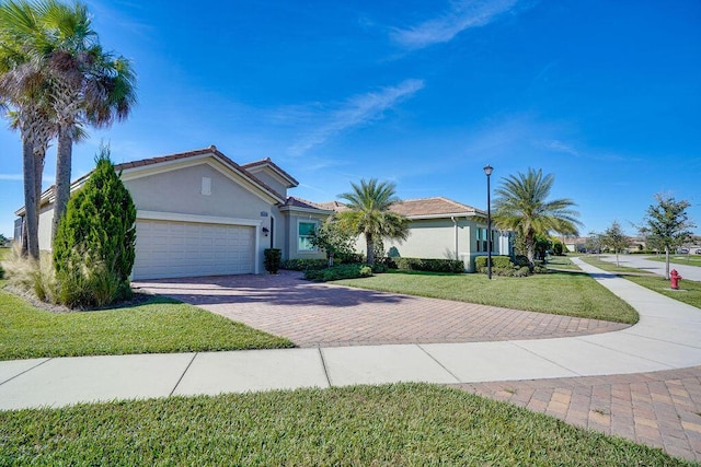 ranch-style home featuring a garage and a front yard