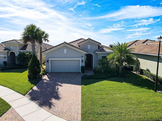 mediterranean / spanish-style home with a garage and a front yard