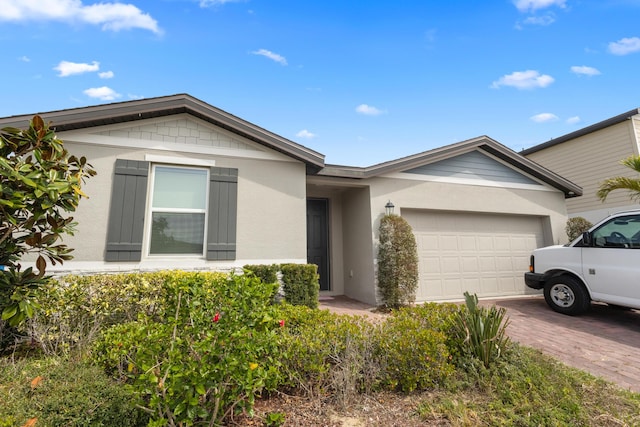 162 Andreas St, Winter Haven, FL 33881 - ranch-style house featuring stucco siding, an attached garage, and driveway