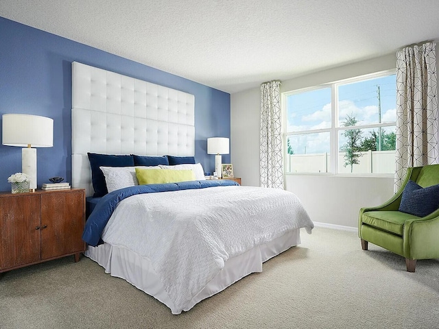 carpeted bedroom featuring a textured ceiling