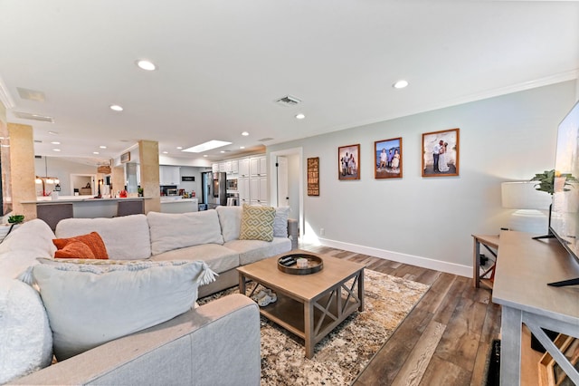 living room with hardwood / wood-style flooring and ornamental molding