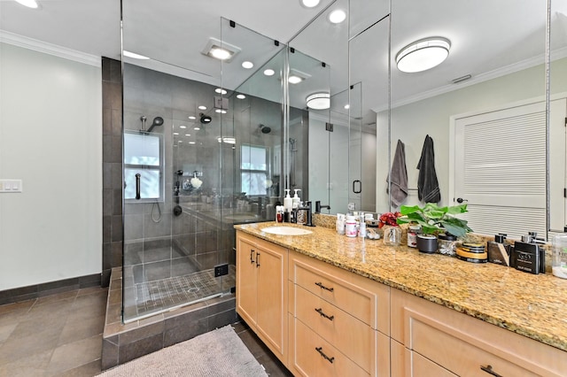 bathroom with vanity, tile patterned flooring, crown molding, and walk in shower