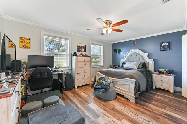 bedroom with dark hardwood / wood-style flooring, ornamental molding, and ceiling fan