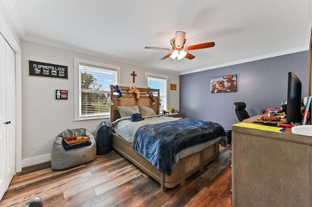 bedroom with crown molding, wood-type flooring, a closet, and ceiling fan