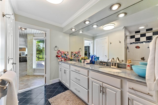 bathroom featuring vanity, crown molding, a shower with shower door, and tile patterned floors