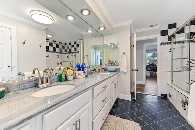 bathroom featuring tile patterned flooring, vanity, and crown molding