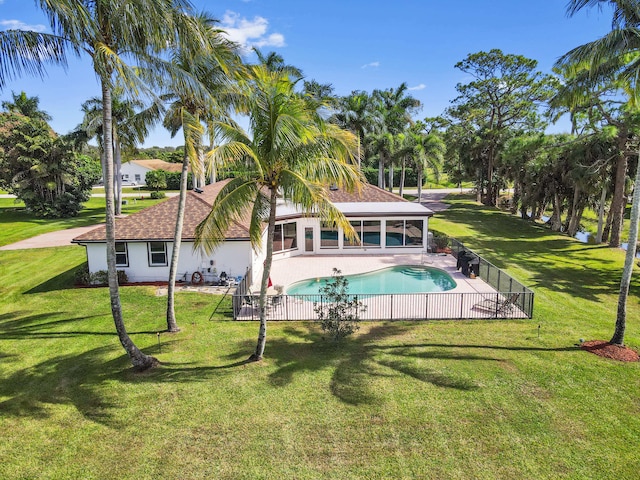 back of property featuring a yard and a sunroom