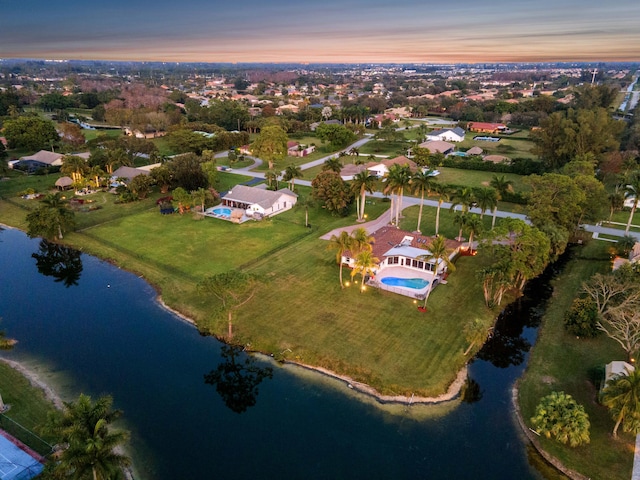 aerial view at dusk with a water view