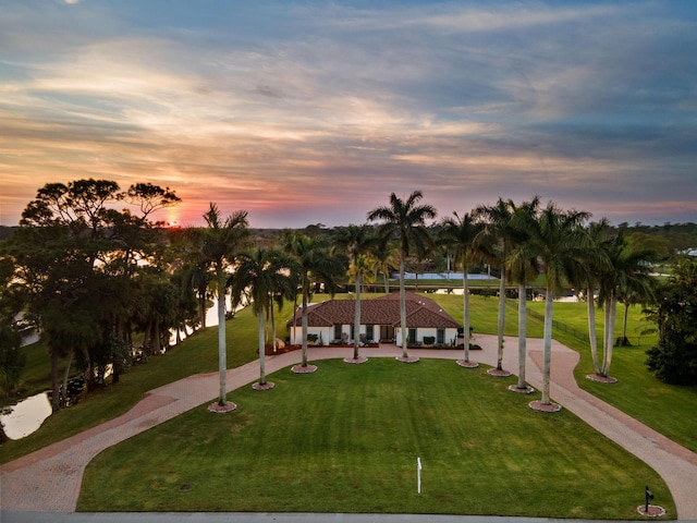 view of home's community with a lawn and a water view