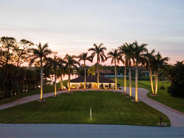 view of property's community with a yard and a water view