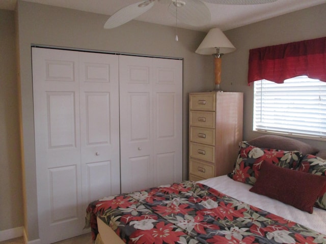 bedroom featuring ceiling fan and a closet