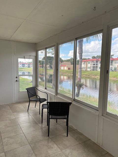 sunroom featuring a water view and plenty of natural light