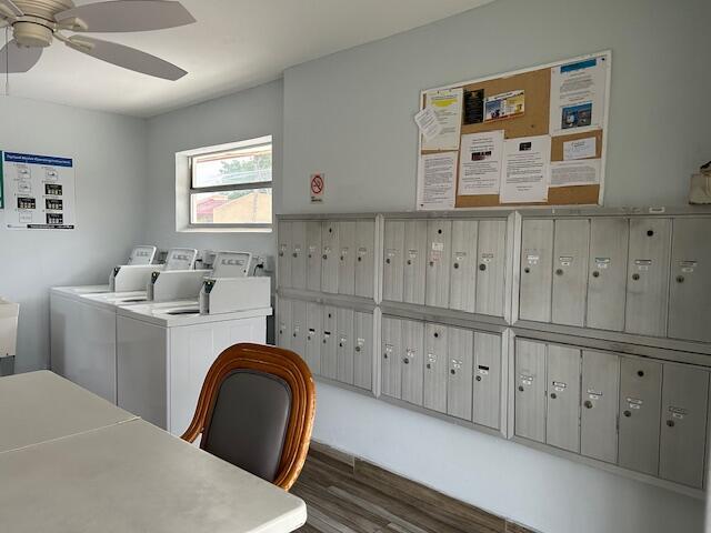 clothes washing area with dark hardwood / wood-style floors and washer and dryer