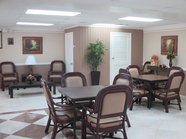 dining space featuring wooden walls