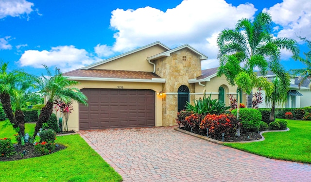 view of front of property with a garage and a front lawn