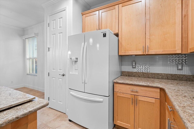 kitchen with white refrigerator with ice dispenser, tasteful backsplash, light stone counters, and crown molding