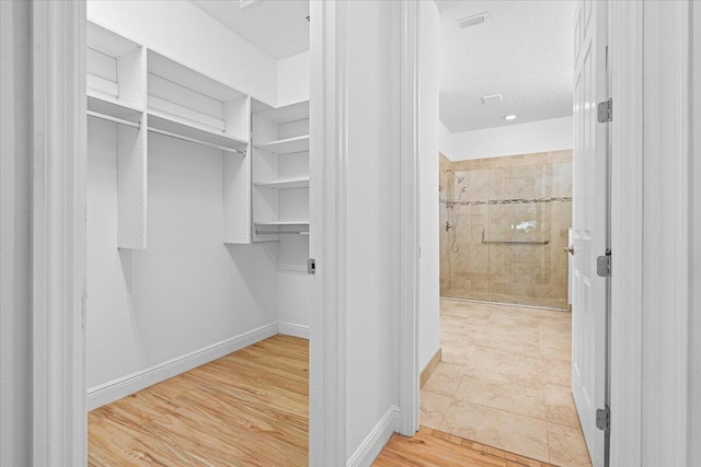 9716 SW Chestwood Ave, Port Saint Lucie, FL 34987 - walk in closet featuring wood finished floors