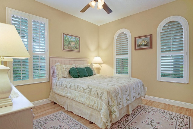 9716 SW Chestwood Ave, Port Saint Lucie, FL 34987 - bedroom with baseboards, a ceiling fan, and wood finished floors