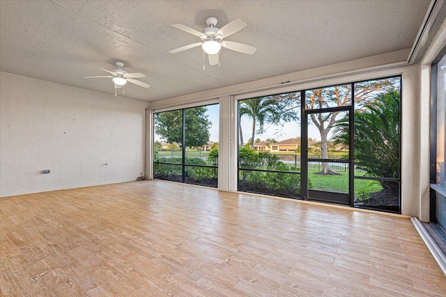 9716 SW Chestwood Ave, Port Saint Lucie, FL 34987 - interior space with a wealth of natural light, a ceiling fan, wood finished floors, and a textured ceiling