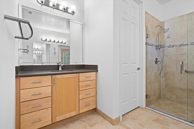 bathroom with vanity and a shower with shower door