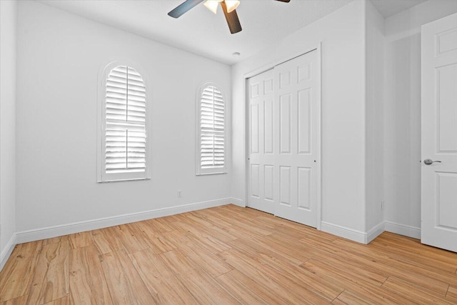 unfurnished bedroom featuring light wood-type flooring, a closet, and ceiling fan