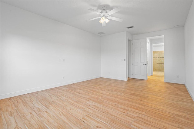 9716 SW Chestwood Ave, Port Saint Lucie, FL 34987 - empty room featuring light wood-type flooring, baseboards, a ceiling fan, and visible vents