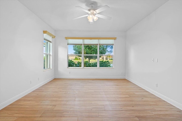 9716 SW Chestwood Ave, Port Saint Lucie, FL 34987 - spare room with ceiling fan, plenty of natural light, light wood-style floors, and baseboards