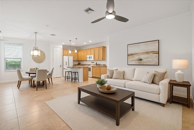 9716 SW Chestwood Ave, Port Saint Lucie, FL 34987 - living area featuring visible vents, a ceiling fan, crown molding, recessed lighting, and light tile patterned flooring