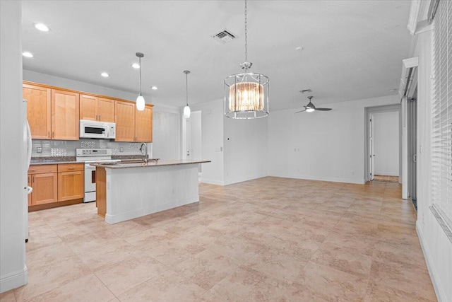9716 SW Chestwood Ave, Port Saint Lucie, FL 34987 - kitchen with white appliances, backsplash, a kitchen island with sink, visible vents, and ceiling fan with notable chandelier