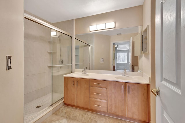 bathroom featuring tile patterned floors, vanity, ceiling fan, and a shower with shower door