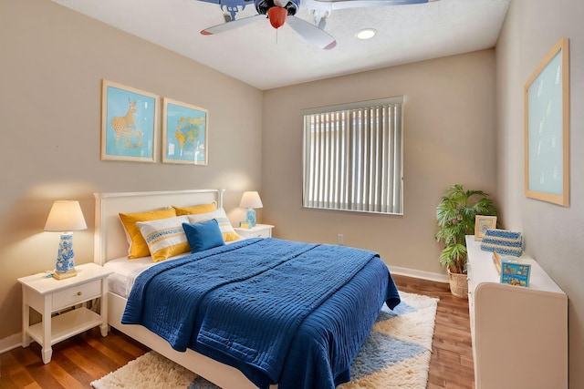 bedroom with wood-type flooring and ceiling fan