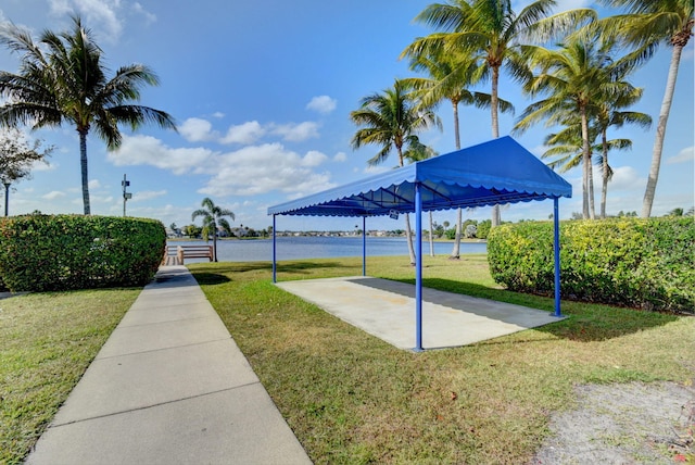 view of home's community featuring a water view and a lawn