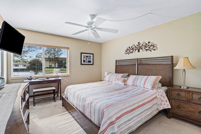 bedroom featuring carpet flooring, a textured ceiling, and ceiling fan