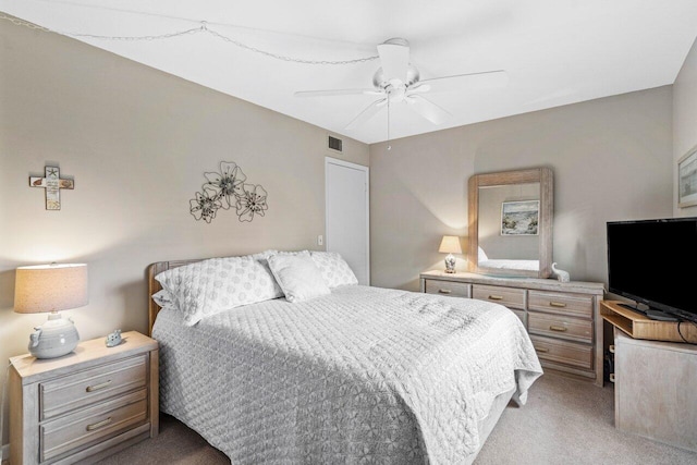 bedroom with ceiling fan and light carpet