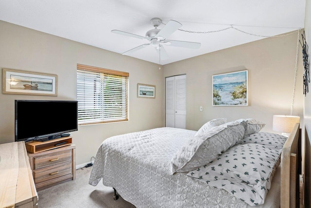 carpeted bedroom featuring a closet and ceiling fan